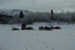 Some members of the team near their snowmobiles.