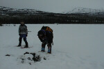 Two team members standing in the snow.