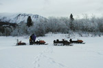 Some members of the team near their snowmobiles.