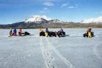 Meteorite recovery team near quads and snowmobiles.